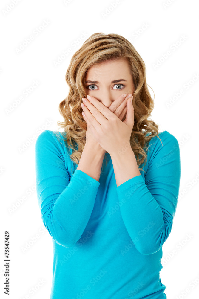 Portrait of a woman covering her mouth Portrait of a woman covering her mouth