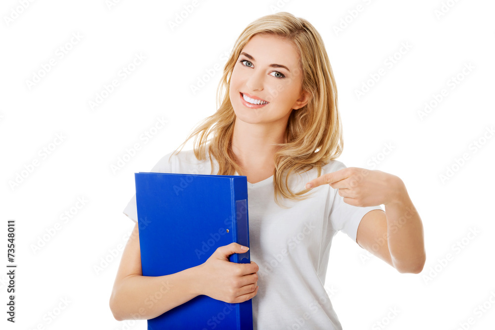 Young woman pointing on her binder Young woman pointing on her binder
