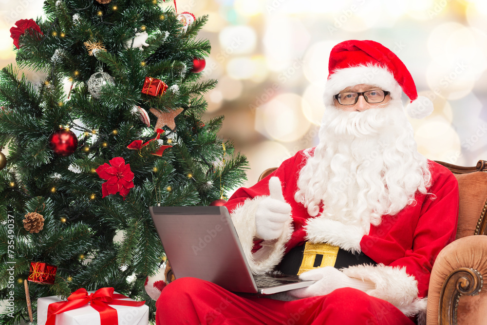 man in costume of santa claus with laptop man in costume of santa claus with laptop