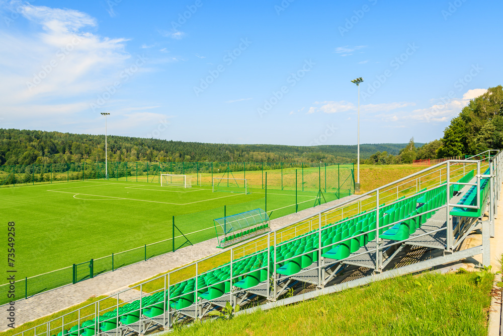 Football stadium and green playing field in rural area of Poland