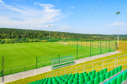 Football stadium and green playing field in rural area of Poland