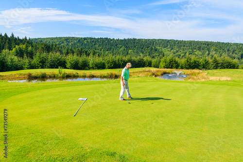 Mature man plays golf in Arlamow hotel, Bieszczady Mountains