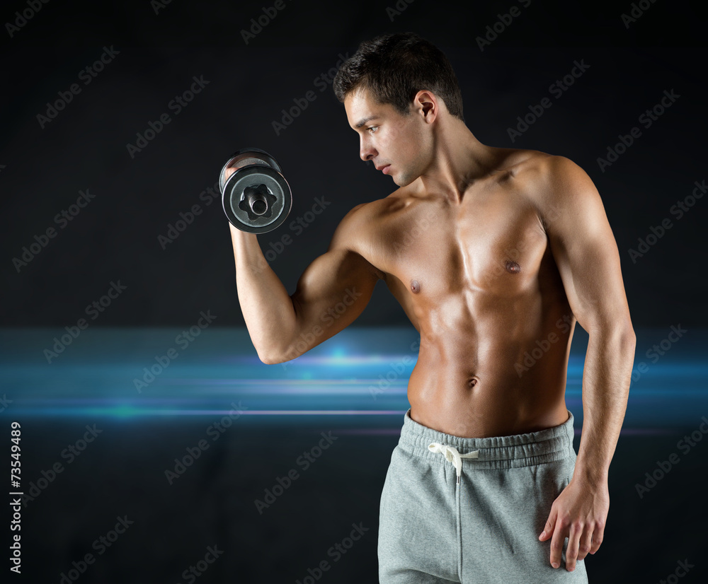 young man with dumbbell flexing biceps