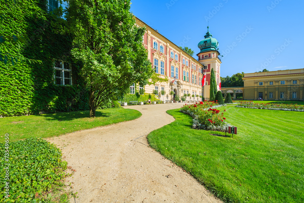 Gardens of beautiful Lancut castle on sunny summer day, Poland