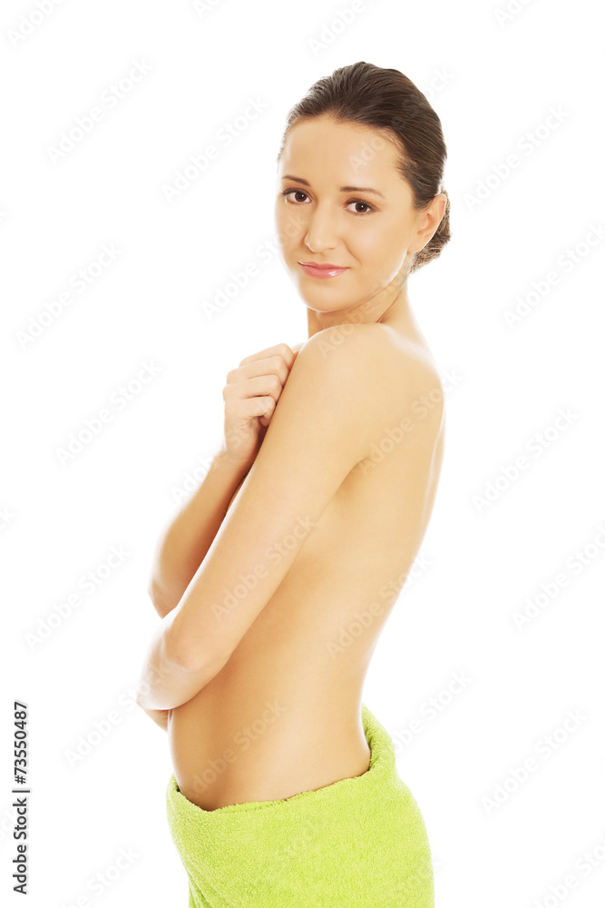 Obraz premium Beautiful happy woman wrapped in towel
