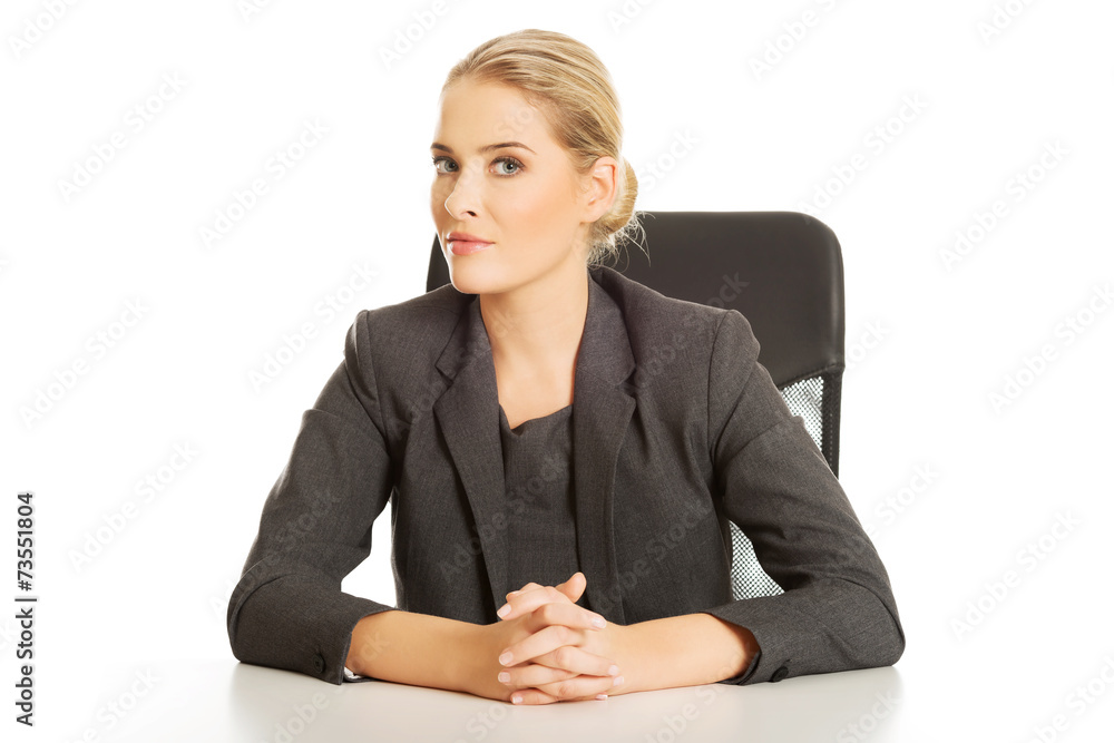 Smiling businesswoman sitting at the desk Smiling businesswoman sitting at the desk