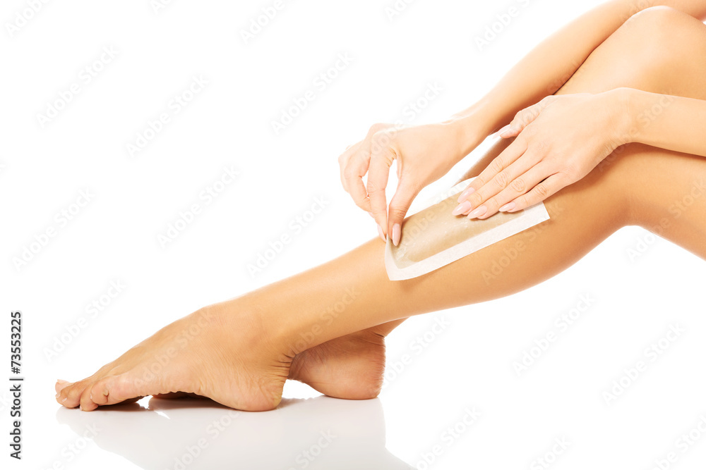 Close up on woman shaving her leg