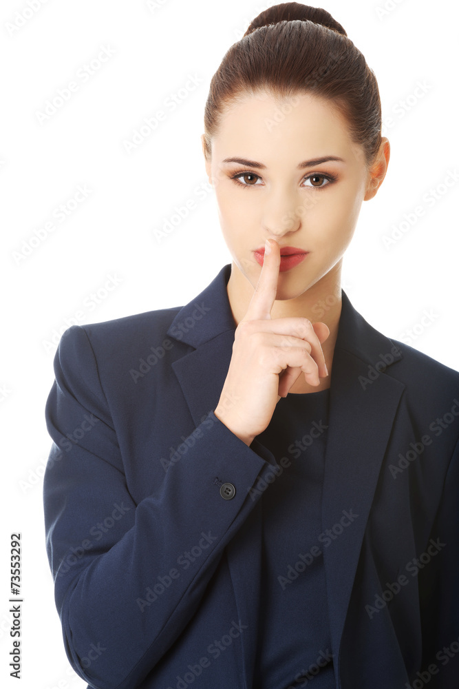 Businesswoman with finger on her lips