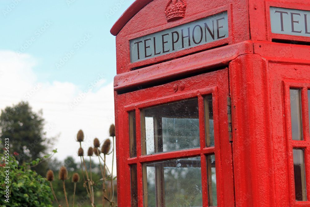 Freshly painted British telephone box painted in bright red Freshly painted British telephone box painted in bright red