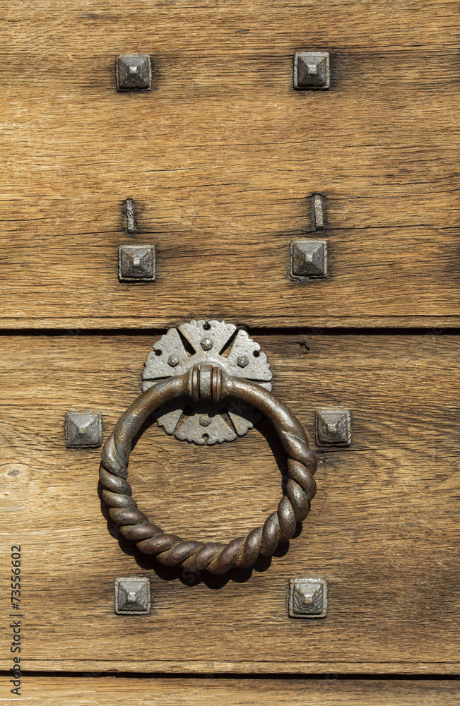 Old wooden background with metal rivets and door knocker Old wooden background with metal rivets and door knocker