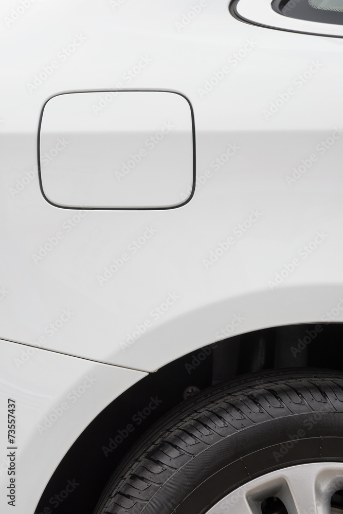 tyre and petrol cap cover and window of a white car