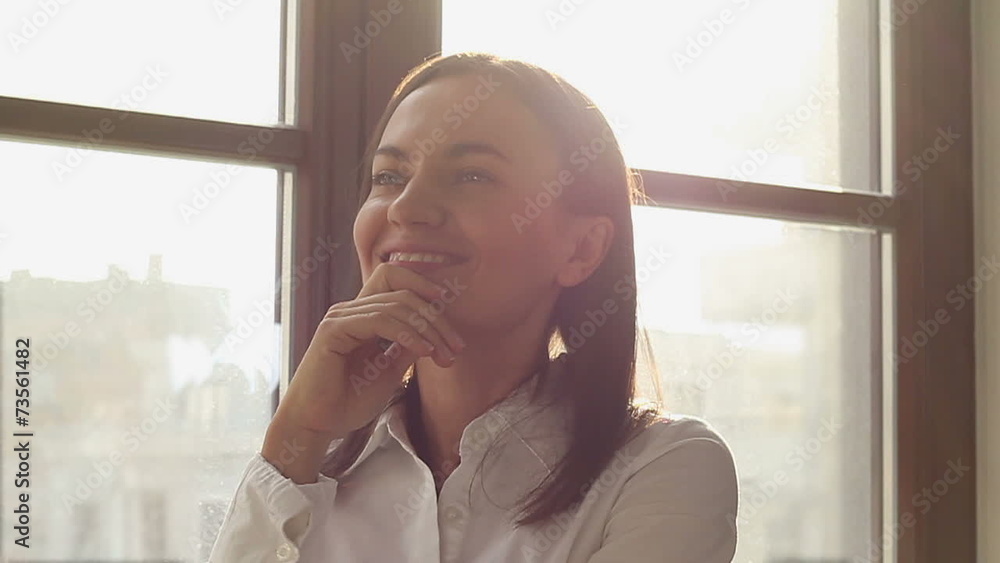 Portrait of a thinking businesswoman at the window, slow motion Portrait of a thinking businesswoman at the window, slow motion
