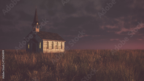 Fotografie Old abandoned white wooden chapel on prairie at sunset with clou