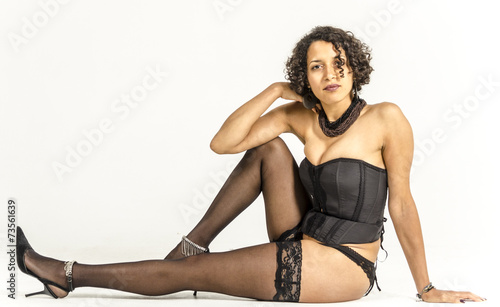 Beautiful young woman in black lingerie and stockings