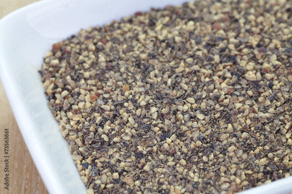 Black pepper powder on a white plate Black pepper powder on a white plate