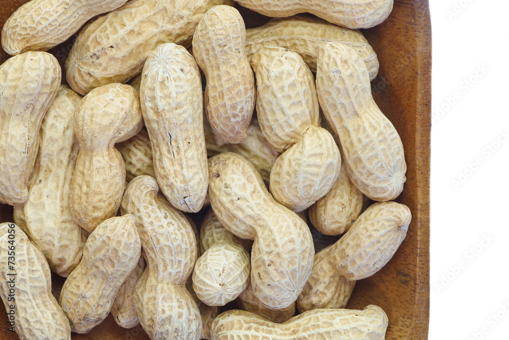 Close - up Raw dried peanut in wood plate