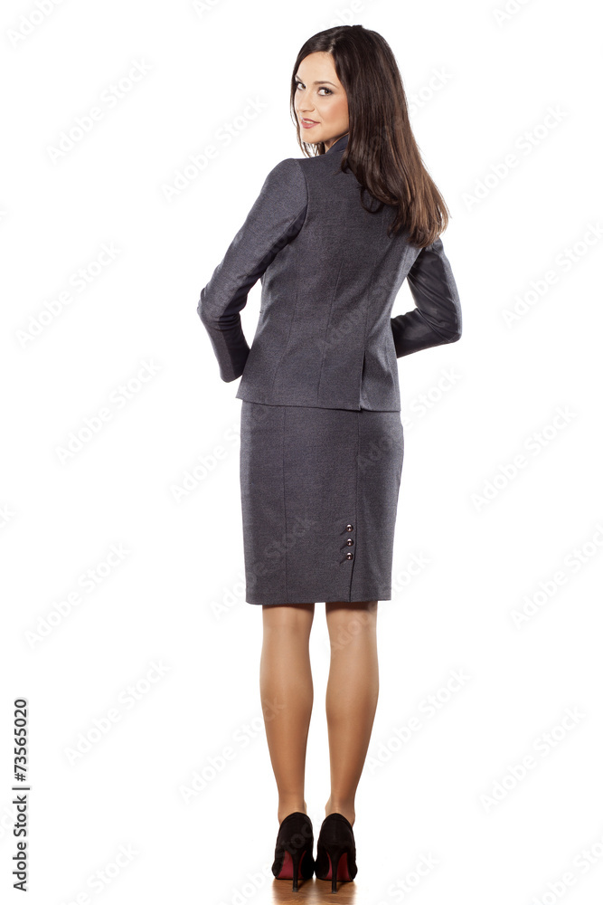 back view of spretty young businesswoman posing on white back view of spretty young businesswoman posing on white