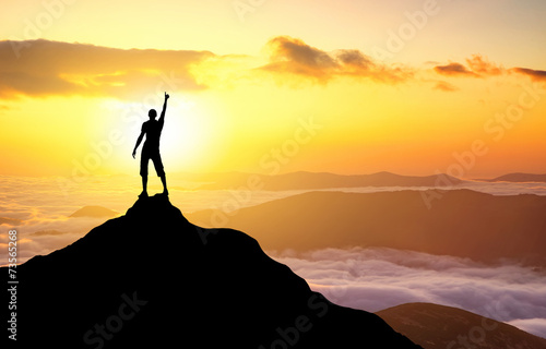 Silhouette of a champion on mountain top