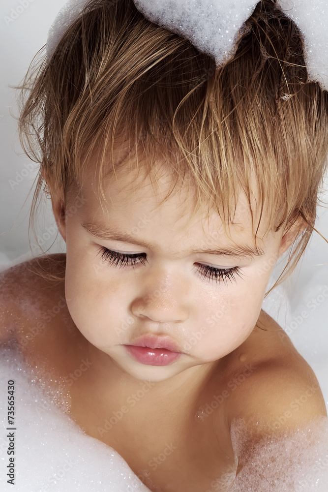 Little girl surrounded soap suds. Little girl surrounded soap suds.