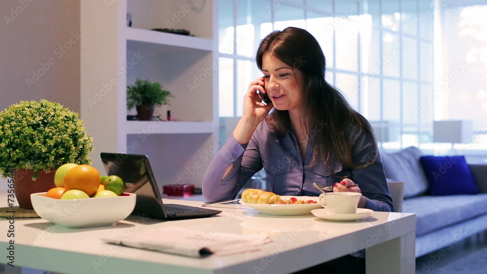 Businesswoman sitting at the table and chatting on cellphone Businesswoman sitting at the table and chatting on cellphone