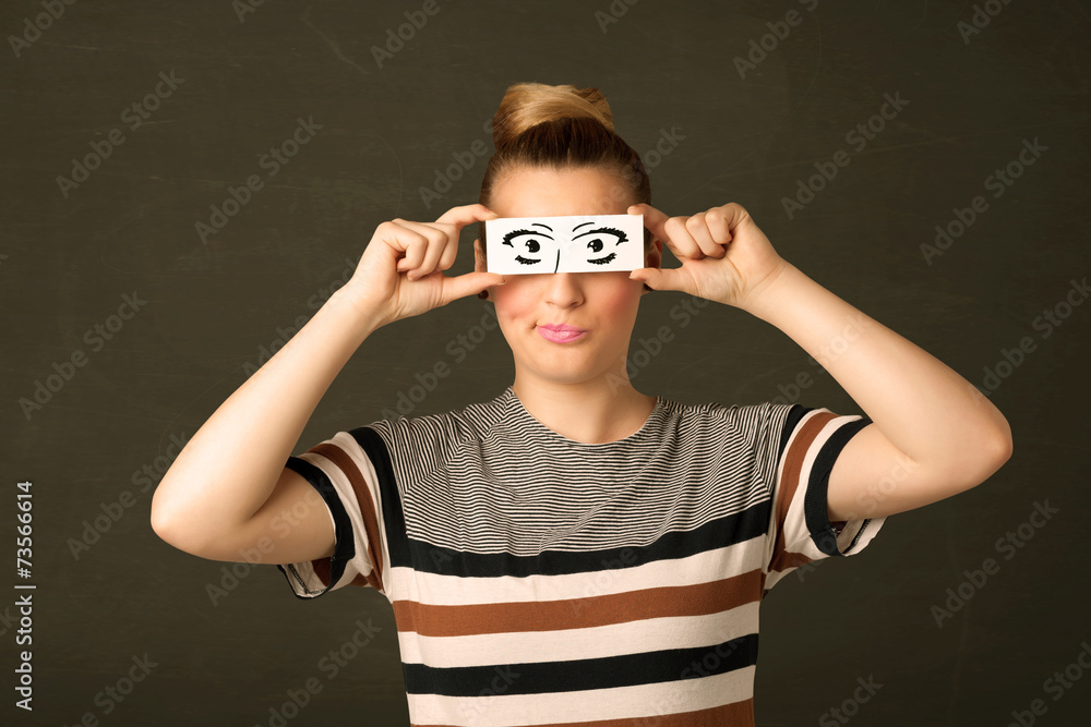 Silly youngster looking with hand drawn eye paper Silly youngster looking with hand drawn eye paper