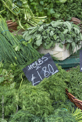 A display of various herbs on a market stall