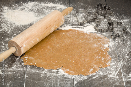 Gingerbread dough with rolling pin and cookie cutters. photo
