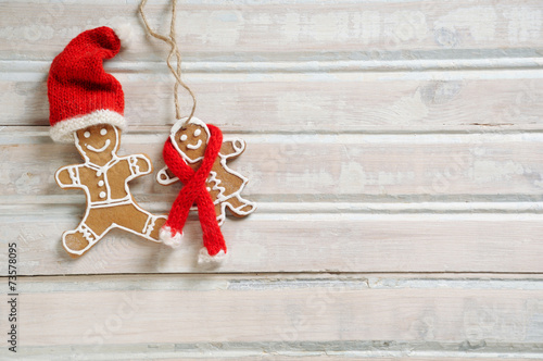 sweet homemade cookies in funny Santa hat for Christmas on white photo