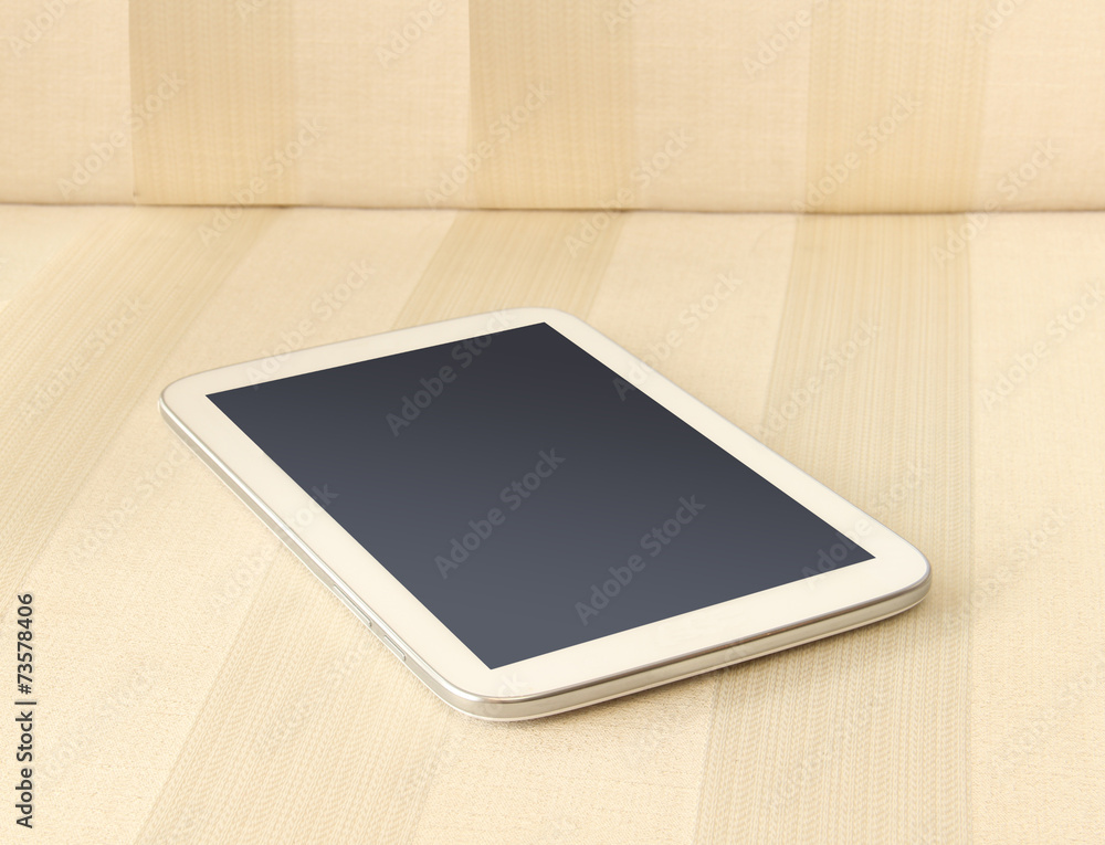 White taplet pc on sofa, Shallow depth of field White taplet pc on sofa, Shallow depth of field