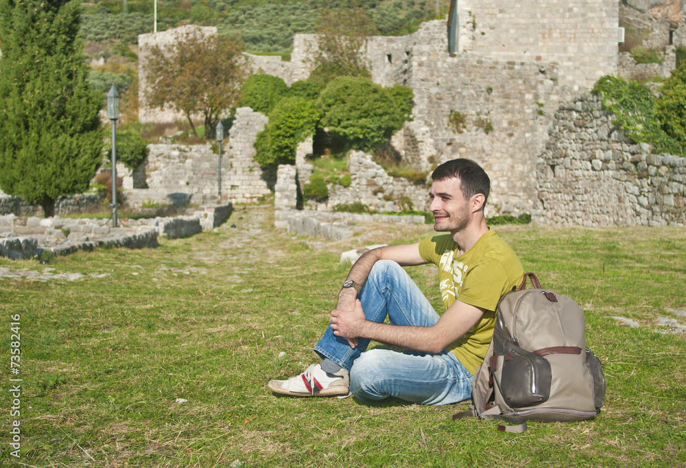 young man sitting on grass young man sitting on grass
