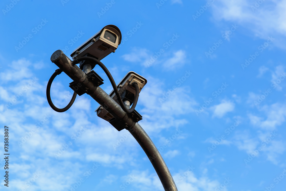 Fototapeta premium Security camera on blue sky background