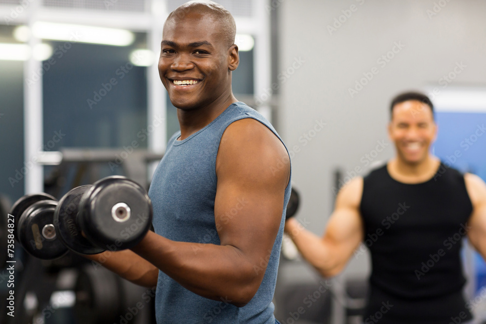 african man working out with dumbbells african man working out with dumbbells