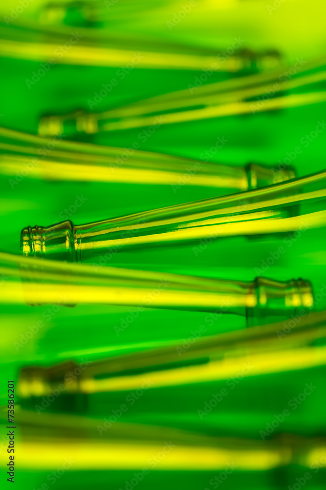 Eight Green Beer Bottles Lying Horizontally Shot with Yellow Lig Eight Green Beer Bottles Lying Horizontally Shot with Yellow Lig