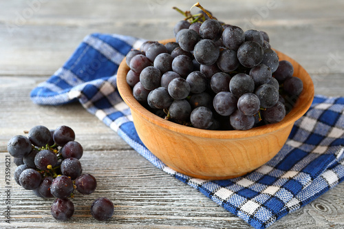 sweet grapes in a wooden bowl