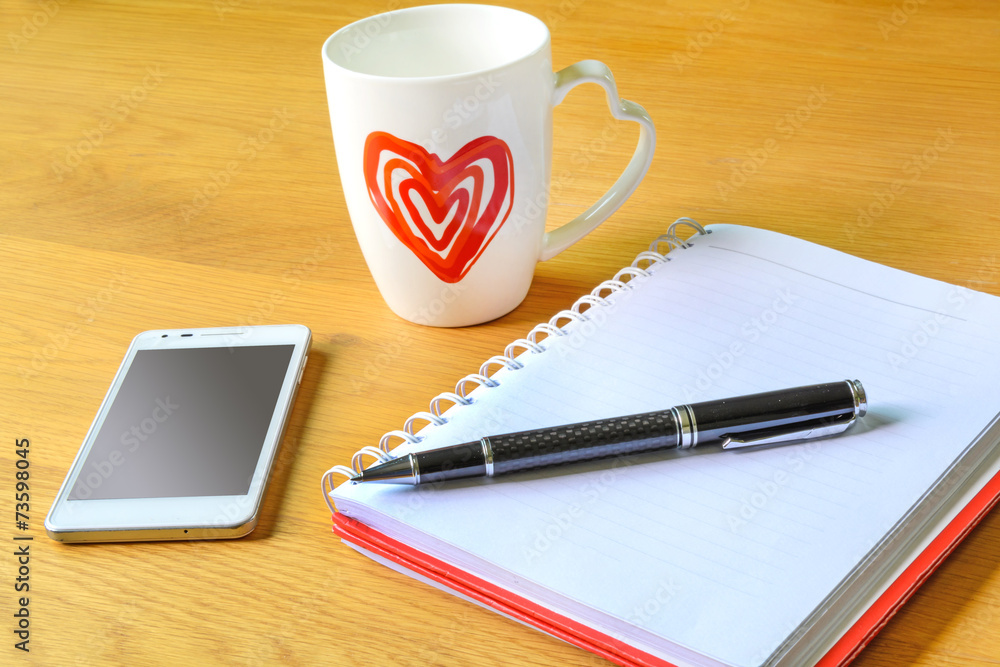 Open a blank white notebook and cup of coffee Open a blank white notebook and cup of coffee