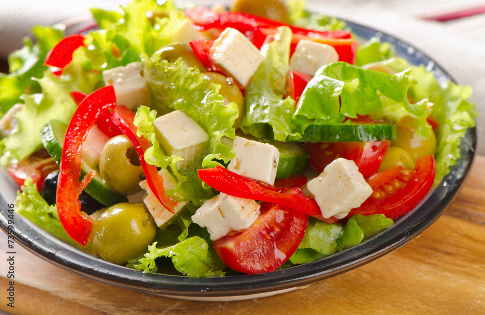 Greek salad with feta and vegetables . Greek salad with feta and vegetables .
