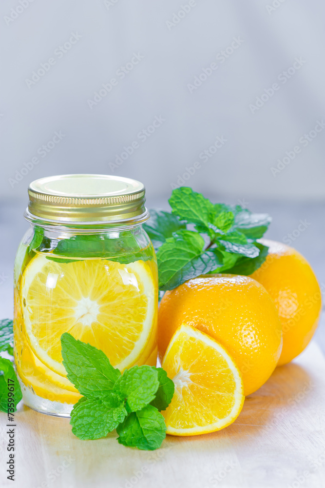 Mug delicious refreshing drink of orange fruit with mint on wood Mug delicious refreshing drink of orange fruit with mint on wood
