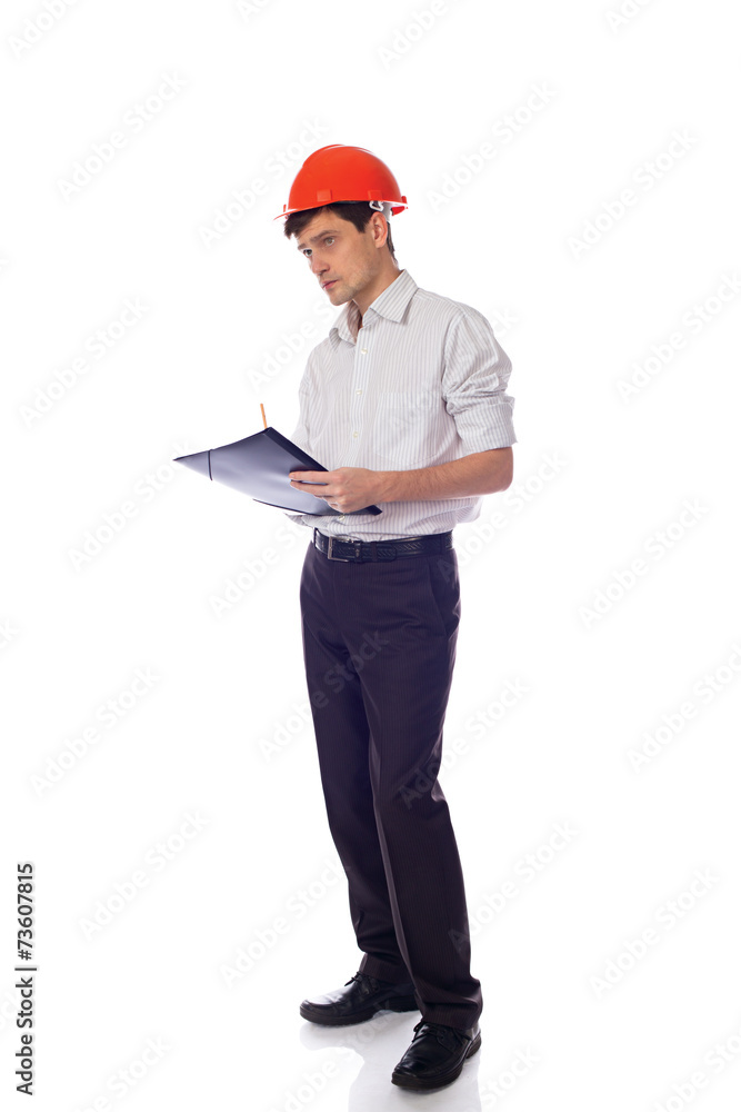 Man in a shirt orange construction helmet writes black folder Man in a shirt orange construction helmet writes black folder