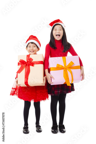 happy little girls showing christmas gift box