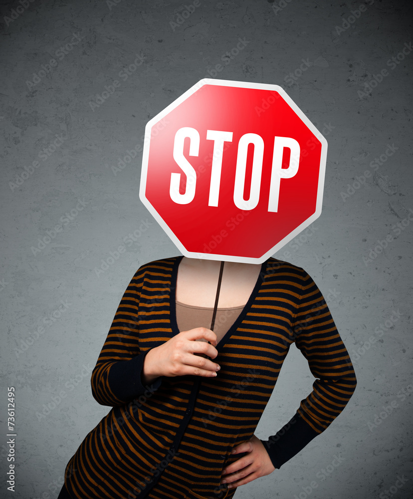Young woman holding a stop sign Young woman holding a stop sign