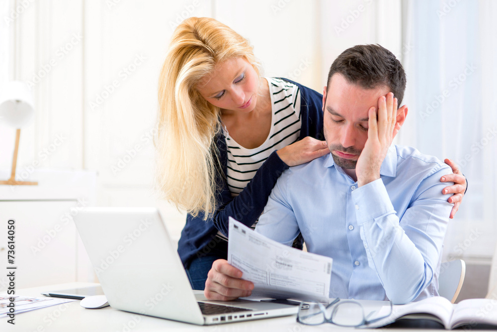 Attractive couple doing administrative paperwork Attractive couple doing administrative paperwork