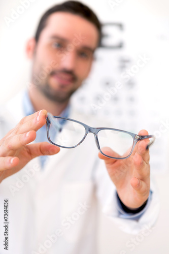 Fototapeta Naklejka Na Ścianę i Meble -  Ophthalmologist make you try new glasses