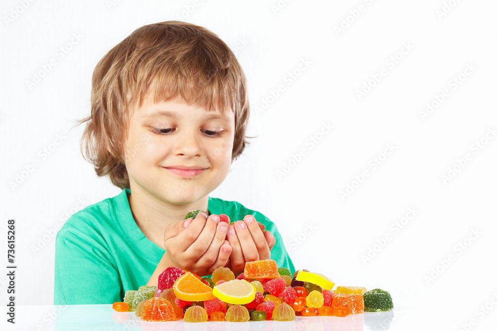 Little blonde child with colored jelly candies Little blonde child with colored jelly candies