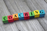concept of coaching word on wooden colorful cubes
