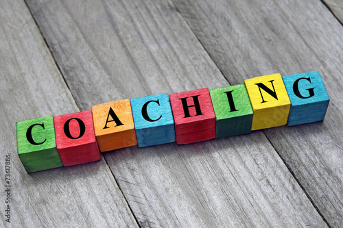 concept of coaching word on wooden colorful cubes