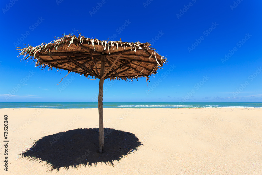 Fototapeta premium Wooden sun umbrella on the beach in Thailand