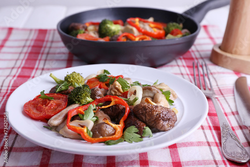 Braised wild mushrooms with vegetables and spices in pan and
