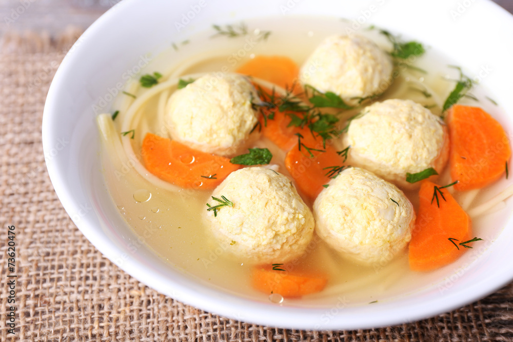 Soup with meatballs and noodles in bowl Soup with meatballs and noodles in bowl