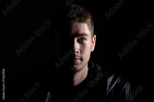 Fotografie Photo of the young man in shadow