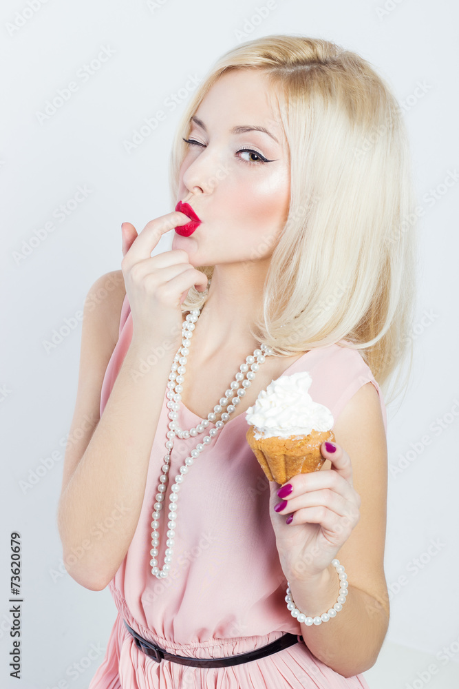 woman sitting with a cupcake and licks sweet cream woman sitting with a cupcake and licks sweet cream